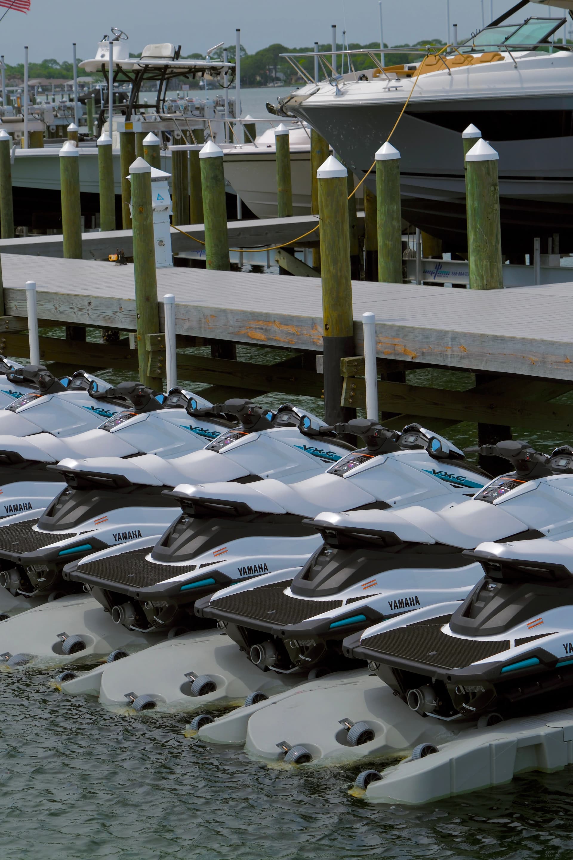 Guest riding a Gulf Island Rentals jet ski on Choctawhatchee Bay, photographed from a side angle with open water behind
